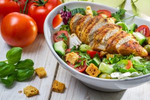 grilled chicken breast over salad